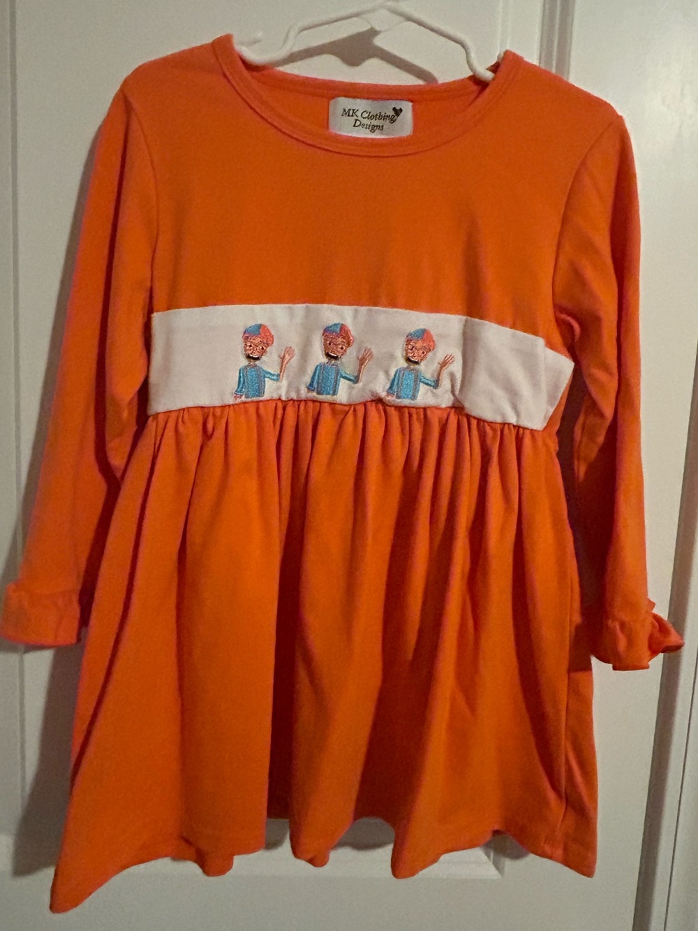 Orange Long-Sleeve Girls Shirt/Dress with White Smocked Band featuring “Blippi”